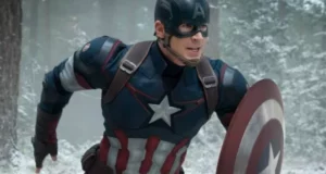 Captain America, as seen at Marvel attractions, dashes through a wintry forest in his iconic blue suit with a star on the chest and signature shield in hand.