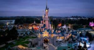 Sleeping Beauty Castle, glowing brilliantly with new lights after a spectacular refurbishment, is the centerpiece of Disneyland Paris at dusk, inviting guests to experience the renewed magic and enchantment that defines this legendary theme park.