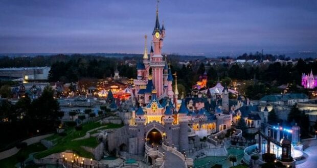 Sleeping Beauty Castle, glowing brilliantly with new lights after a spectacular refurbishment, is the centerpiece of Disneyland Paris at dusk, inviting guests to experience the renewed magic and enchantment that defines this legendary theme park.