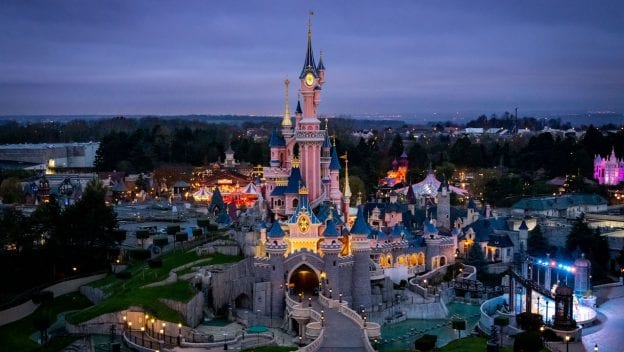 Sleeping Beauty Castle, glowing brilliantly with new lights after a spectacular refurbishment, is the centerpiece of Disneyland Paris at dusk, inviting guests to experience the renewed magic and enchantment that defines this legendary theme park.