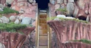 Splash Mountain stands eerily dry, its iconic log flume ride stripped of rushing water. Guests in their log vehicles speed toward the legendary drop, only to be greeted by a bold "No water" sign overhead and experience a bone-dry landing where cascading splashes should be.