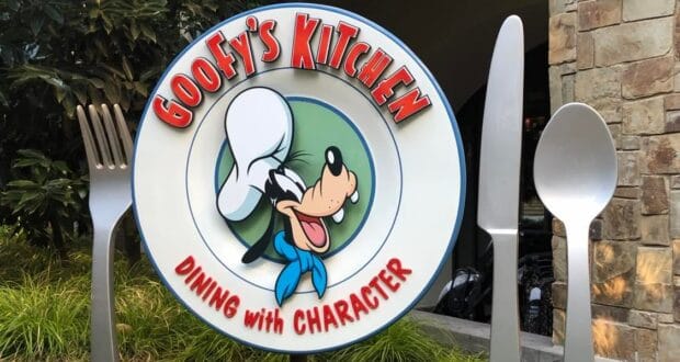 The vibrant Goofy's Kitchen sign features Goofy in his signature chef hat, playfully posed beside oversized fork and spoon props, welcoming guests at Disneyland.