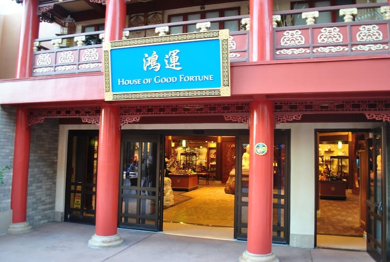 Bold red pillars mark the entrance to House of Good Fortune at EPCOT’s World Showcase, inviting guests with open doors and colorful merchandise displays that capture the lively spirit of Disney Parks shopping.