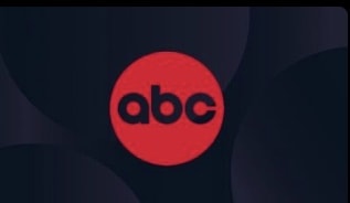 A red circle featuring the iconic lowercase black "abc" letters stands out against a dark backdrop, evoking the energetic branding seen across ABC’s theme park entertainment experiences and streaming platforms like Disney+.