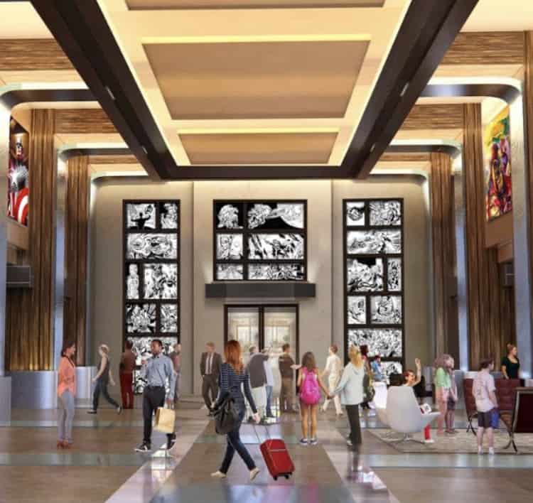 Fans and travelers gather in a sleek hotel lobby filled with Marvel-inspired artwork and travel bags by the door, capturing the excitement of planning adventures to magical destinations like Disneyland Paris.