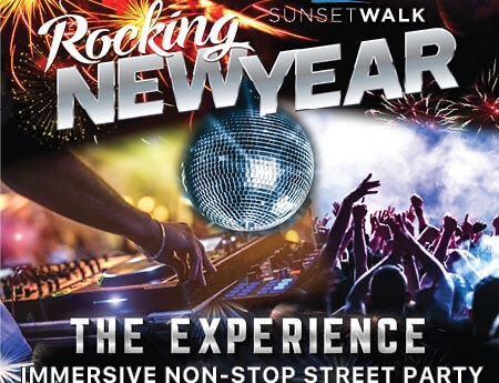 New Year’s Eve street party at Sunset Walk in Walt Disney World, featuring a dynamic DJ set, spectacular fireworks lighting up the night, a sparkling disco ball overhead, and an enthusiastic crowd dancing and celebrating.