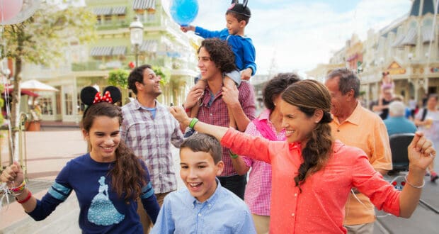 Guests stroll joyfully through Walt Disney World, clutching colorful balloons and dressed in festive vacation outfits, delighting in the park’s magical atmosphere as they create unforgettable memories together.