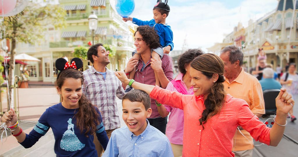 Guests stroll joyfully through Walt Disney World, clutching colorful balloons and dressed in festive vacation outfits, delighting in the park’s magical atmosphere as they create unforgettable memories together.