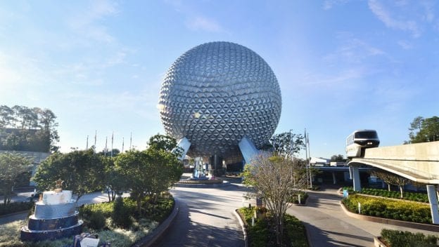 Spaceship Earth stands tall at Epcot as the monorail glides past beneath a clear blue sky, perfectly showcasing the magic and excitement that define Walt Disney World and its unforgettable experiences.