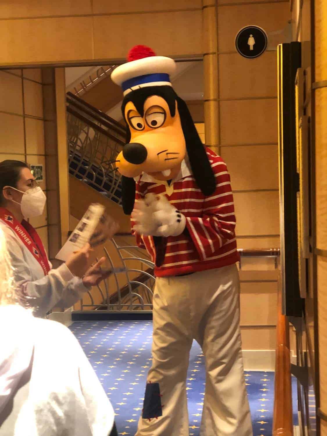 Goofy in his sailor outfit greets a guest in the hallway of a Disney Cruise Line ship, capturing the enchanting character moments that are part of the My Disney Cruise Line Experience During Covid Part 3: Characters.