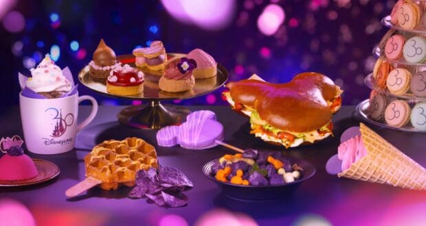 A vibrant array of Disney-themed desserts and snacks, specially crafted to celebrate 30 Years of Disneyland Paris Food and Beverage magic, displayed on a festive table with a magical bokeh backdrop.