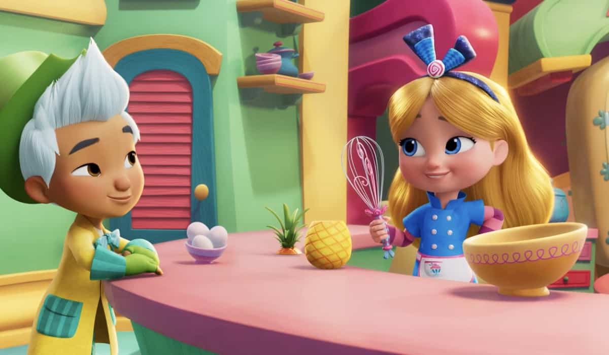 Young guests in Alice’s Wonderland Bakery’s vibrant kitchen set beam with delight, surrounded by whimsical eggs, a playful pineapple, and signature baking utensils straight from the Disney Junior show.
