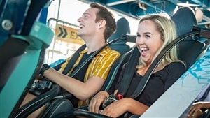 Excited guests laugh together as they await the launch of Central Florida’s latest roller coaster on its much-anticipated opening day.