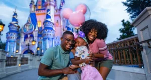 A Florida resident family beams with joy in front of Cinderella Castle at Walt Disney World, holding iconic pink Mickey Mouse balloons and celebrating their special ticket discounts for locals.