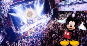 Mickey Mouse welcomes fans in front of a vibrant concert crowd and dazzling stage lights indoors, joining the excitement as live music and tours make their big return—better than ever—at House of Blues Orlando.