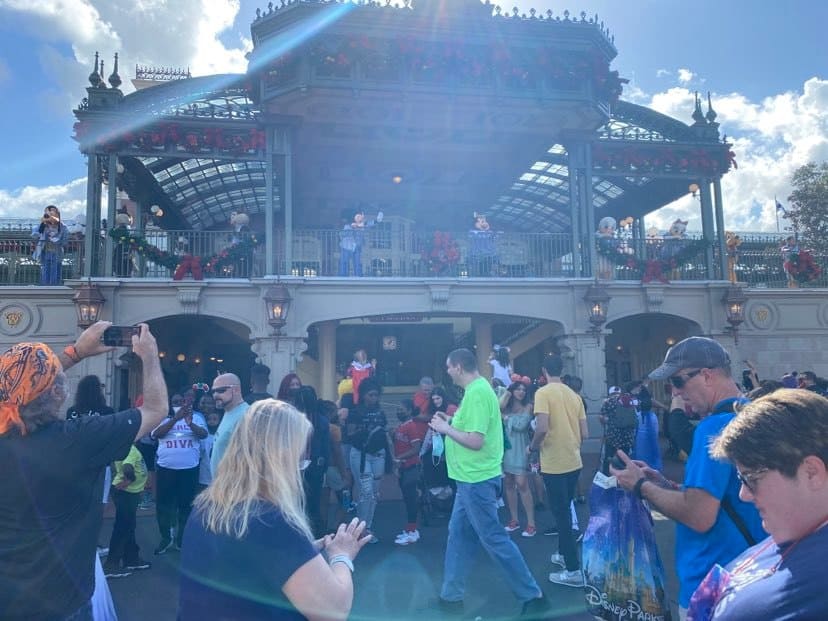 Mickey and Minnie with crowds at Main Street Train Station