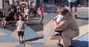 Unforgettable Disneyland moment: A young boy beams for the camera at Disneyland, then receives the ultimate surprise when a uniformed Cast Member kneels down and welcomes him with a big hug, creating a magical memory he'll never forget.