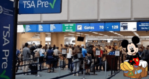 Mickey Mouse, suitcase in hand, joins the excited crowd waiting at the TSA PreCheck line at Orlando International Airport, celebrating the surge of travelers heading to Disney World and other theme parks.