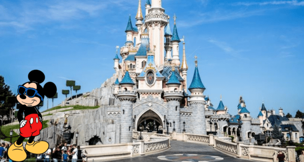 Mickey Mouse, sporting cool sunglasses, poses in front of Disneyland’s iconic fairytale castle under clear blue skies. The energy is infectious as fans discuss the latest major policy change sweeping through Disney Park.