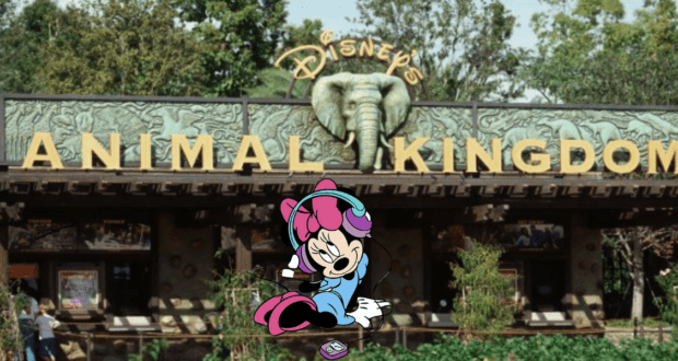 Mickey Mouse sports headphones at the entrance to Disney’s Animal Kingdom, set against a backdrop of lively music and signature Disney excitement filling the park atmosphere.