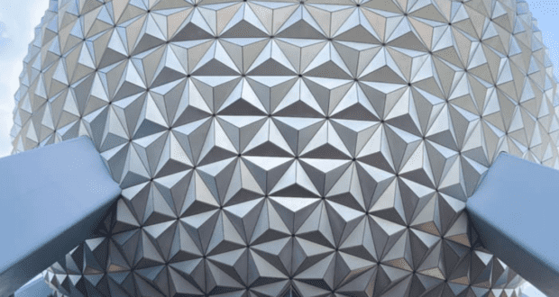 Close-up of EPCOT’s iconic Spaceship Earth, showing its gleaming silver triangular panels and sturdy support beams, embodying the cutting-edge design and excitement found at Disney Parks.