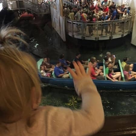 child-waving-Pinocchio-village-haus-to-small-world-boat