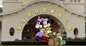 Mickey and Minnie Mouse pose with their suitcases in front of the BOARDWALK entrance, setting the scene for an exciting arrival at Disney’s BoardWalk Resort—an iconic Disney World experience that captures all the fun and anticipation of starting your magical vacation.