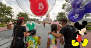 A family holding colorful Mickey Mouse balloons strolls toward Cinderella Castle at Disney World, with a playful cartoon Mickey Mouse in the corner—capturing a magical Disney moment you’ll remember long after your visit.
