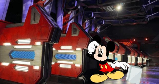 Mickey Mouse greets excited visitors next to sleek, red ride vehicles inside a Disney World attraction, just steps away from the high-energy adventure of Guardians of the Galaxy: Cosmic Rewind—where thrill-seekers should prepare for an unforgettable experience (and maybe some motion sickness).