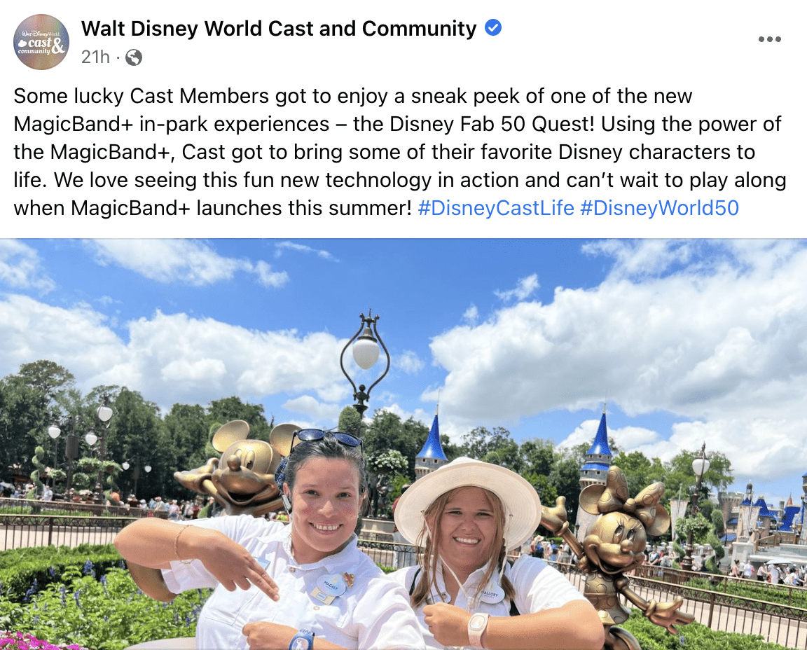 Cast Members beam with excitement as they showcase MagicBands in front of Cinderella Castle and shimmering golden Disney character statues, marking the highly anticipated MagicBand+ debut at Walt Disney World.