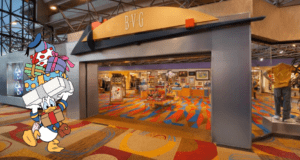 Donald Duck, arms full of gifts, greets guests outside a sparkling BVG store that glows like a classic Disney resort shop. Through the windows, bursts of vivid carpet and dazzling merchandise displays invite visitors to dive into the magic inside.