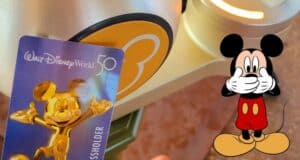 Disney World Annual Passholder card showcasing Mickey Mouse alongside a bright yellow ticket scanner, with an illustrated Mickey playfully covering his mouth.