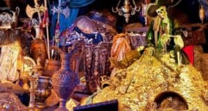 Jack Sparrow’s skeletal double, complete with his signature hat, lounges atop a glittering mound of gold coins and shimmering treasures, surrounded by lavish props that bring to mind the immersive magic of Disneyland’s newly enhanced Pirates of the Caribbean attraction.