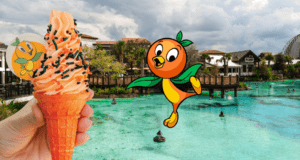 Enjoy a refreshing Orange Bird DOLE Whip ice cream cone beside the waterfront at Magic Kingdom, with the adorable Orange Bird character and enchanted, storybook-style buildings creating a whimsical Disney backdrop.