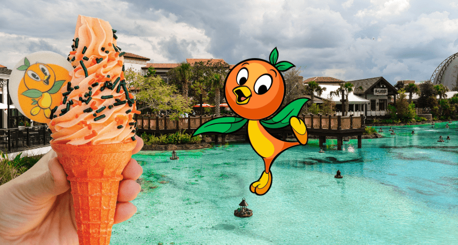 Enjoy a refreshing Orange Bird DOLE Whip ice cream cone beside the waterfront at Magic Kingdom, with the adorable Orange Bird character and enchanted, storybook-style buildings creating a whimsical Disney backdrop.