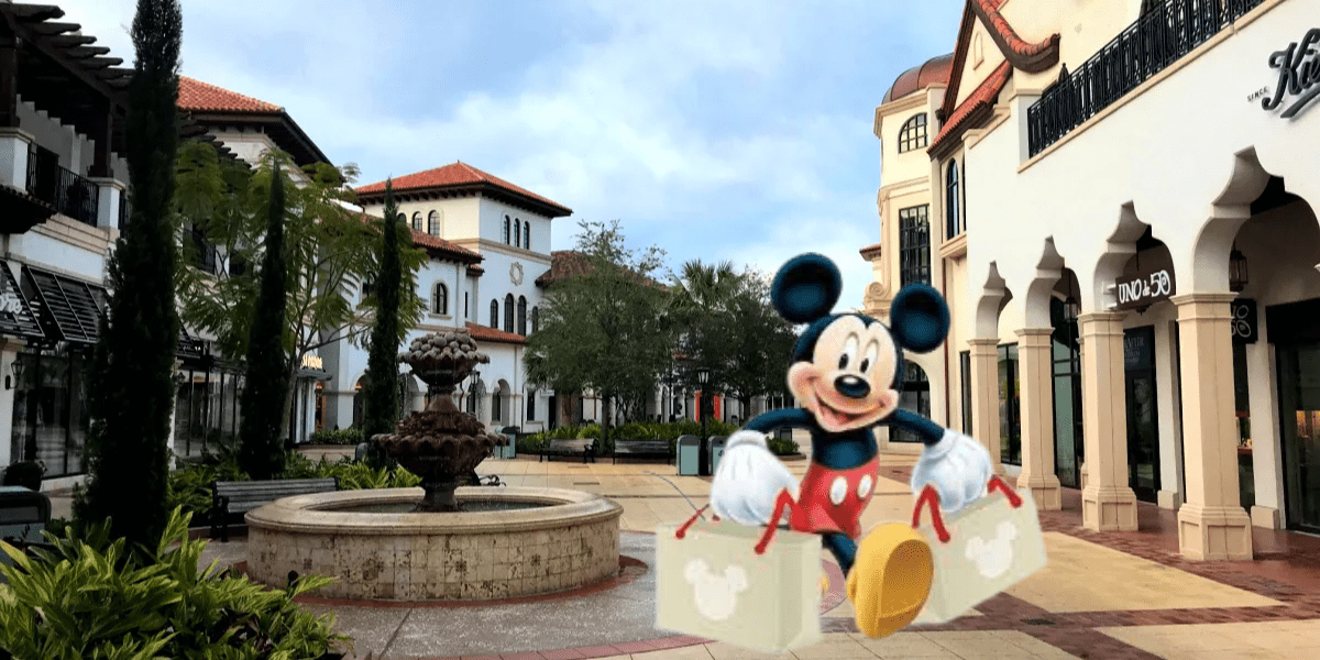 Mickey Mouse strolling through Disney Springs, arms full of shopping bags brimming with Disney souvenirs, against the lively backdrop of a sparkling fountain and an array of iconic Disney shops.