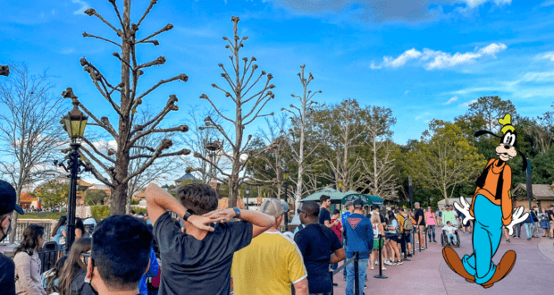 Guests line up outside beneath clear blue skies and leafless trees, with Goofy joining the crowd as everyone eagerly waits to grab a bite at a popular EPCOT quick-service spot.