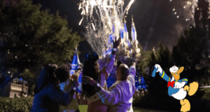 Guests gather in front of Cinderella Castle at Walt Disney World, marveling at a vibrant fireworks display as Donald Duck waves nearby. Their MagicBand+ wristbands light up and pulse in perfect sync with the magical nighttime spectacular.