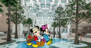 Mickey and Minnie Mouse, ready for adventure with their suitcases, greet guests in a lively, modern terminal filled with natural light and lush trees under a glass ceiling, bringing Disney magic to Orlando International Airport Terminal C.