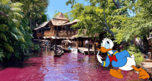 Donald Duck by the Jungle Cruise’s pink-hued river, posing near a rustic wooden cabin nestled among lush green trees in Adventureland.