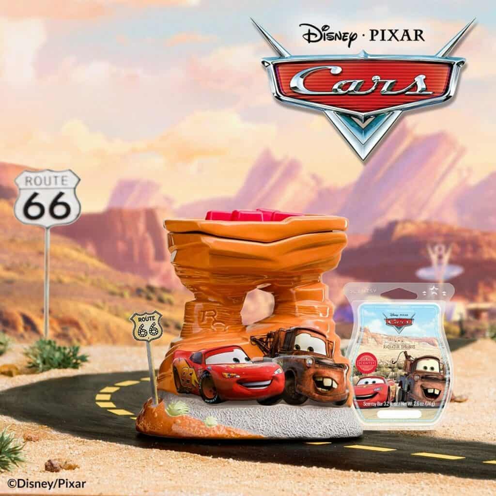 Lightning McQueen and Mater toy figures race down Route 66 in front of the Cars logo, set against a vibrant desert backdrop—bringing the excitement of Radiator Springs from Disney Parks to your collection.