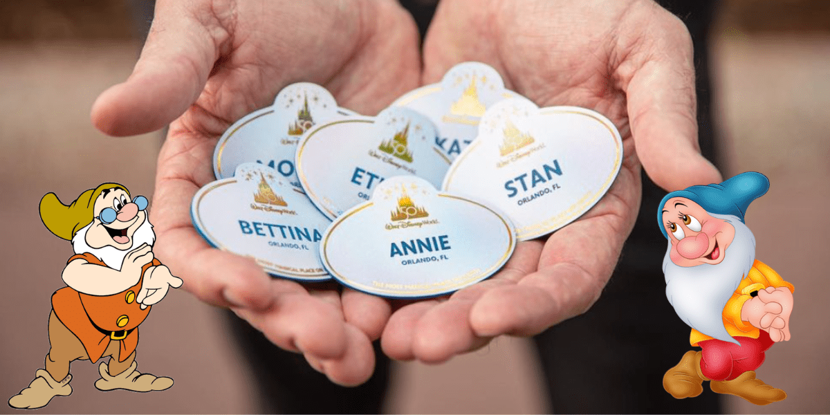Disney Cast Member name tags are held up, flanked by two smiling cartoon dwarfs from Snow White admiring the tags—capturing that heartwarming Disney magic perfect for sharing a Cast Compliment.