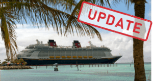 A Disney Cruise Line ship docked by a vibrant tropical shoreline, with "UPDATE" boldly stamped in red across the photo, signaling the latest cruise testing news for Disney fans.