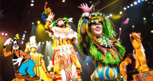 Goofy greets the crowd from center stage as a lively group of costumed dancers performs around him, capturing all the excitement and dynamic spirit of Disney’s Festival of the Lion King.