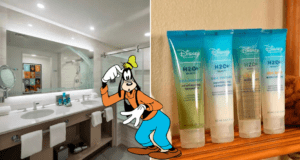Goofy poses by the bathroom counter inside a Disney H2O Resort room, with a lineup of Disney H2O+ bath products ready for guests.