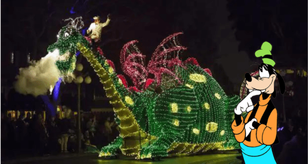 Elliott the glowing dragon float, breathing plumes of smoke at night and carrying his young rider, steals the show in the Main Street Electrical Parade as Goofy waves from the right, all aglow with dazzling lights against the nighttime magic of Disneyland.