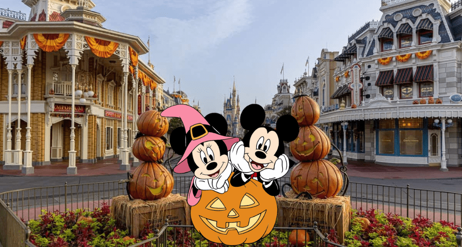 Mickey and Minnie dressed in festive Halloween costumes greet guests beside cheerful Mickey-shaped pumpkins at the elaborately decorated entrance of Main Street, U.S.A. in the Disney park.