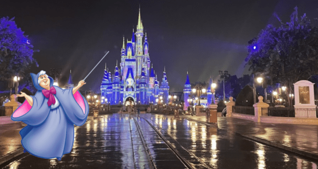 The Fairy Godmother greets guests on a rain-kissed walkway in front of Cinderella Castle, bathed in nighttime glow and ready to make wishes come true during Magic Kingdom Extended Evening Hours.
