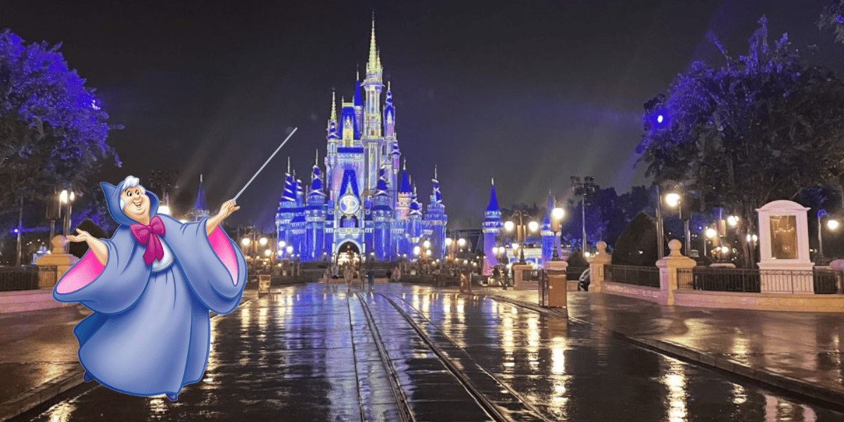 The Fairy Godmother greets guests on a rain-kissed walkway in front of Cinderella Castle, bathed in nighttime glow and ready to make wishes come true during Magic Kingdom Extended Evening Hours.