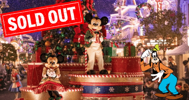 Mickey and Minnie greet guests at Mickey's Very Merry Christmas Party, surrounded by festive decorations, as a "SOLD OUT" sign is displayed and Goofy waves nearby at Magic Kingdom.
